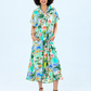 Quinn mint lemon dress, front view full length with hands in side pockets