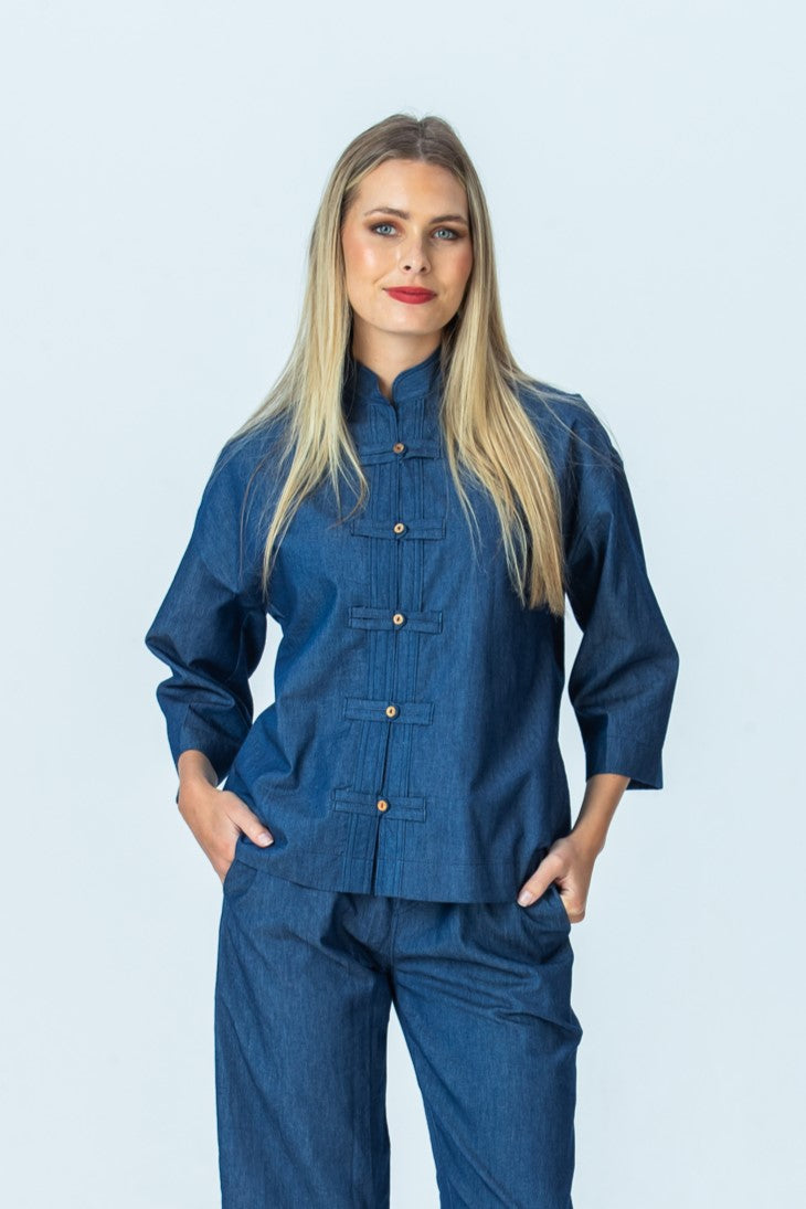 Kinsley denim kaftan-style shirt, front view with hands in pockets, styled with Parker pants