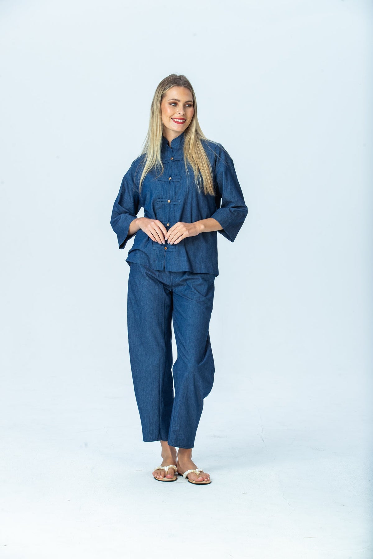 Parker denim barrel pants, front view full length, hands together, looking to the side
