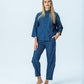 Parker denim barrel pants, front view full length with hand in pocket, one knee bent