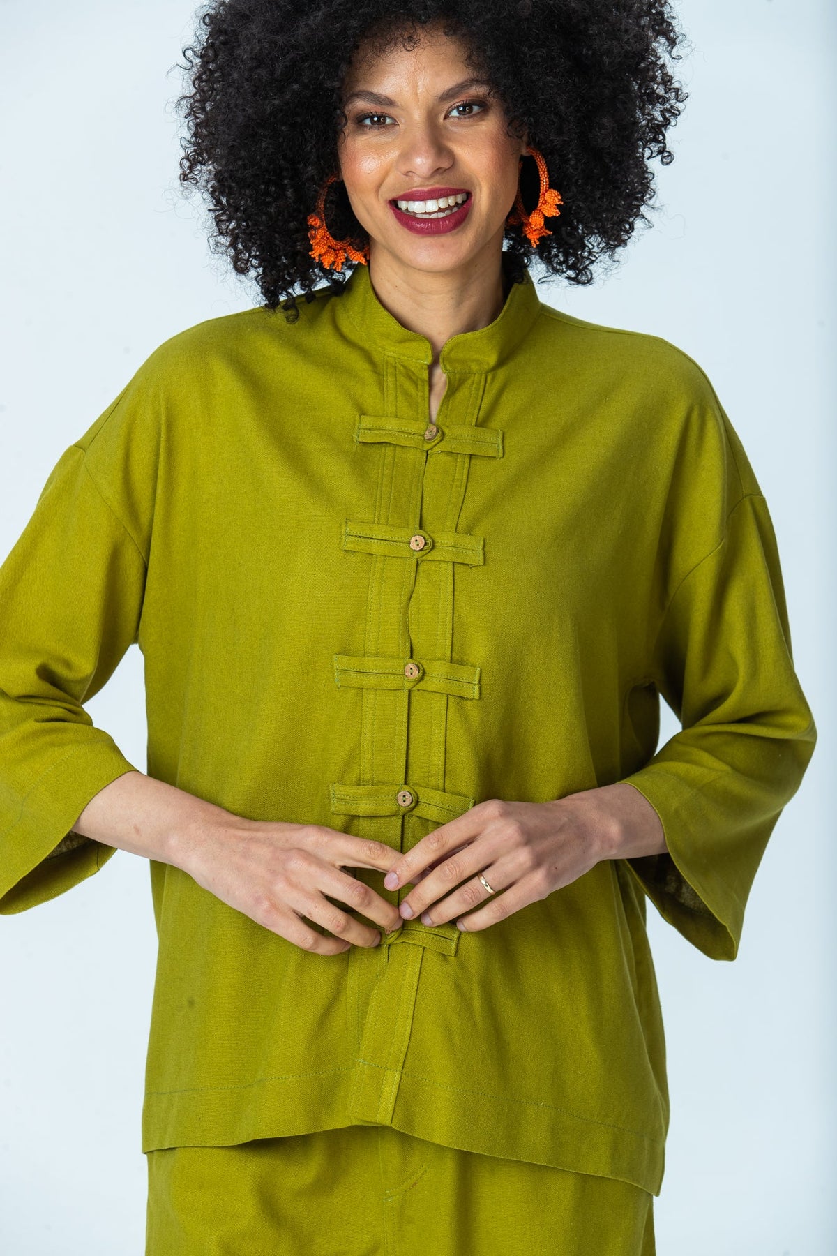 Kinsley chartreuse kaftan-style shirt, close up of mandarin collar and frog fastenings