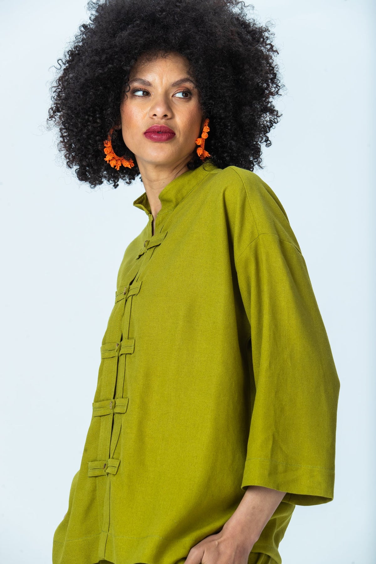 Kinsley chartreuse kaftan-style shirt, three-quarter view looking over the shoulder