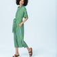 Hollis blue green stripe shirt dress, side view walking with hand in pocket