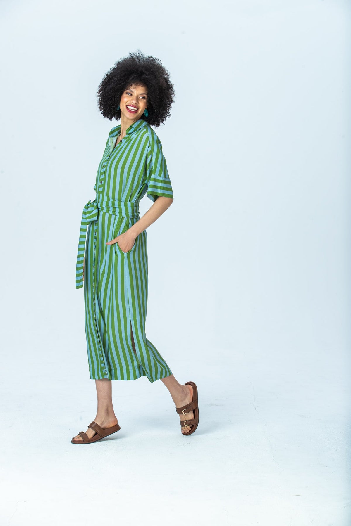 Hollis blue green stripe shirt dress, side view walking with hand in pocket