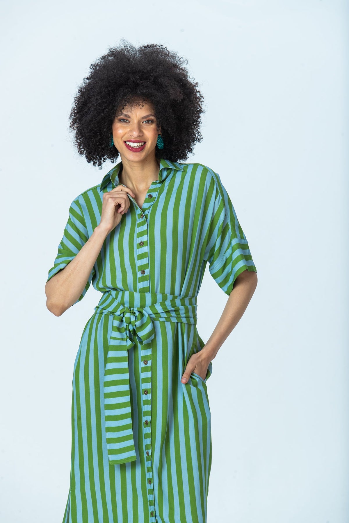 Hollis blue green stripe shirt dress, front view with hand at collar and hand in pocket