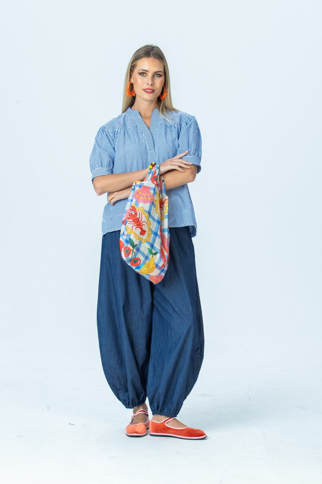 Tatum blue stripe shirt, front view full length with arms crossed