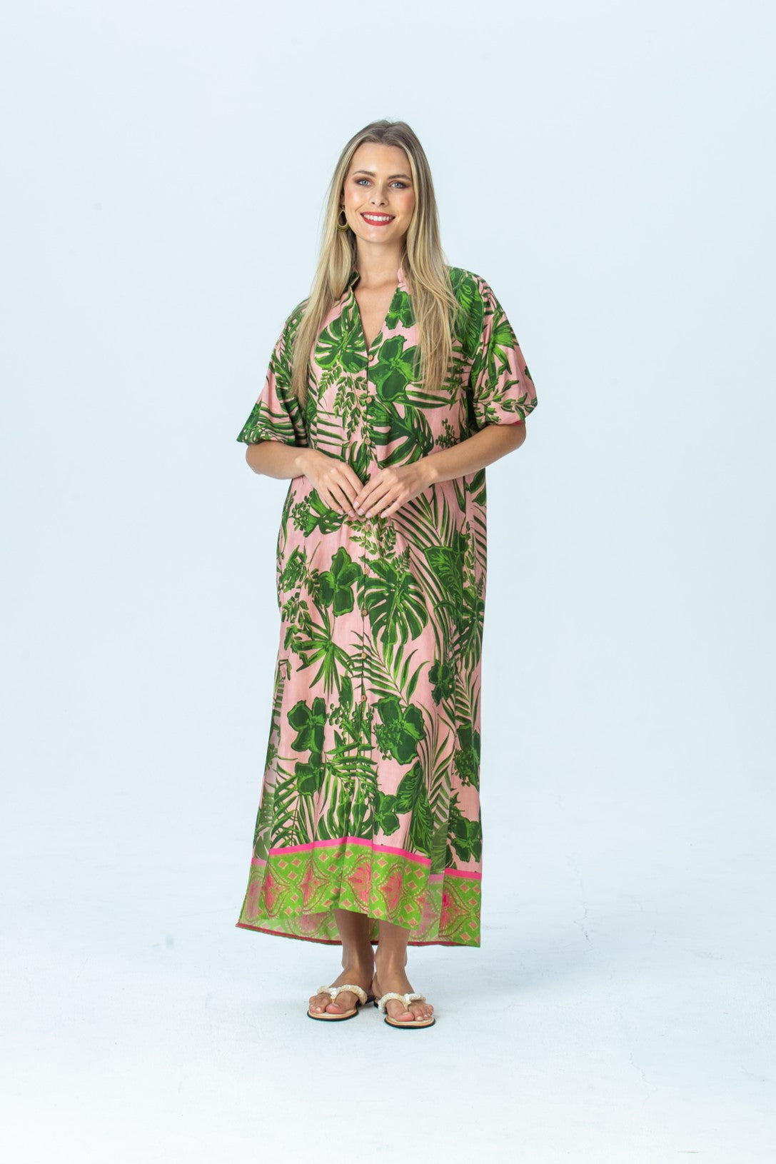 Bailey pink tropical kaftan, front view full length with hands together