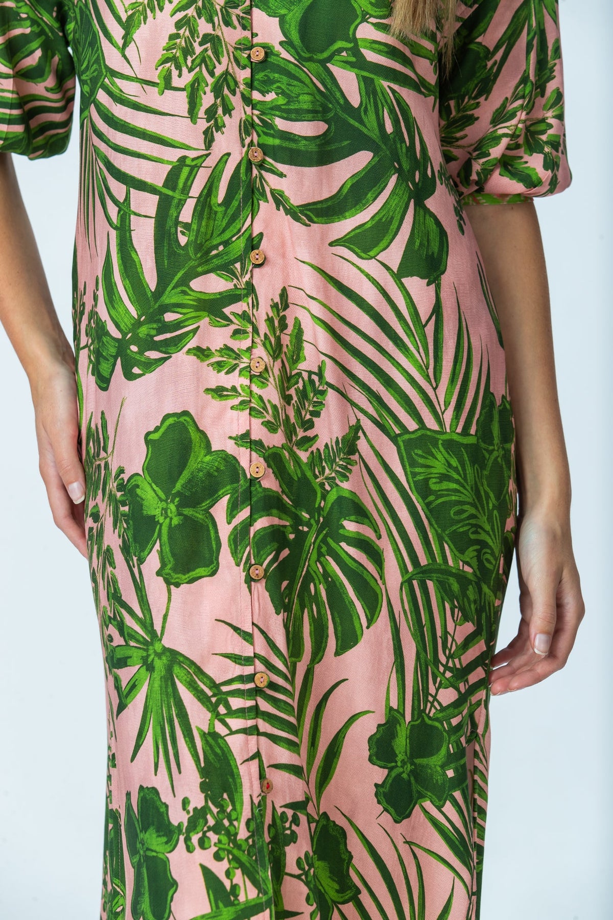 Bailey pink tropical kaftan, close up of button-through front and red thread button