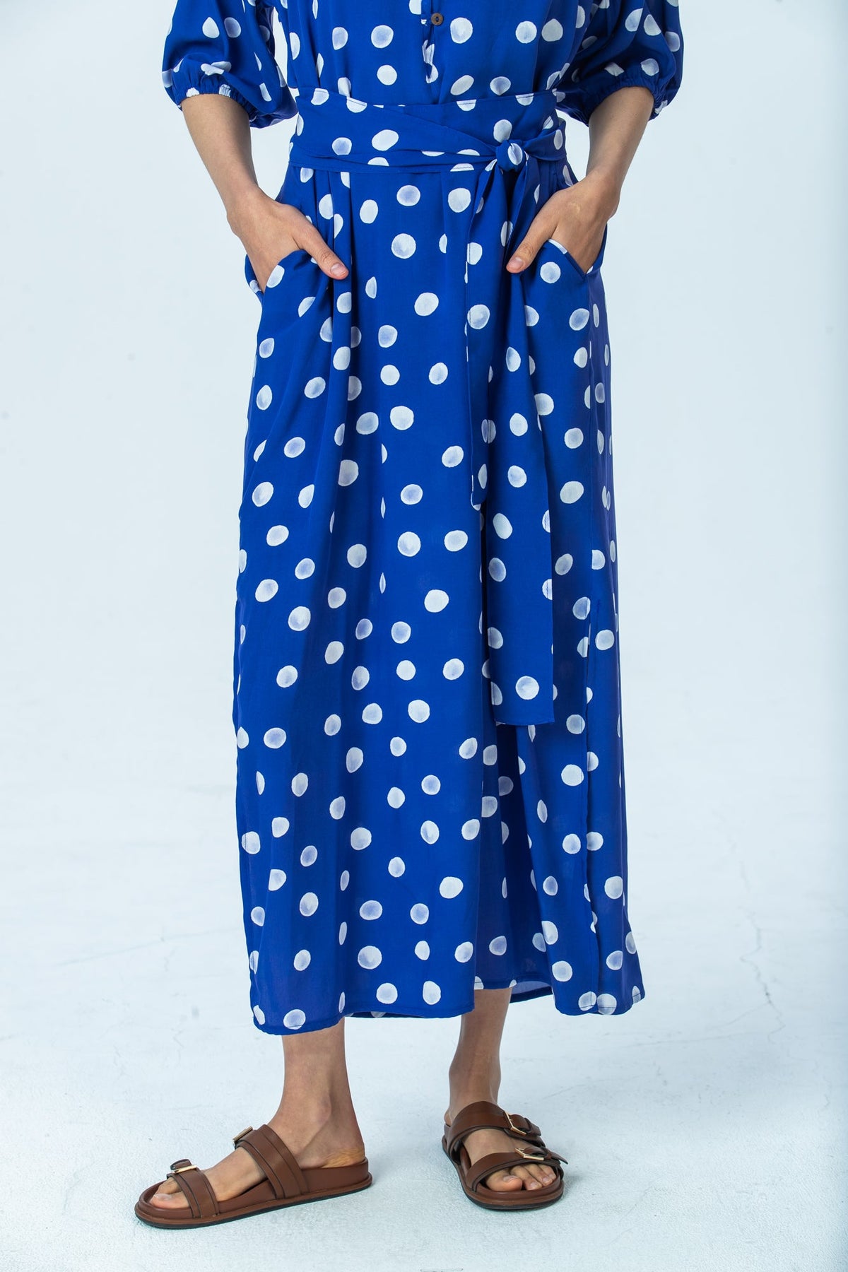 Sloane royal blue polka dot dress, close up of skirt, pockets and belt ends