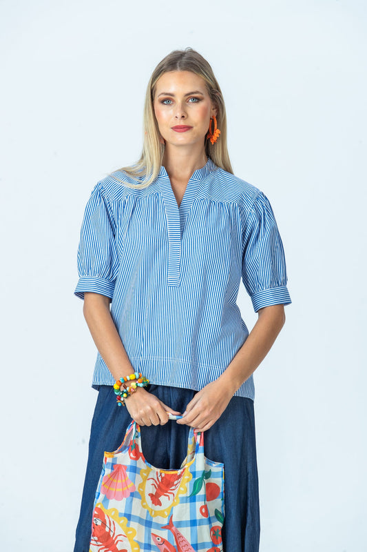 Tatum blue stripe shirt, front view holding a printed tote