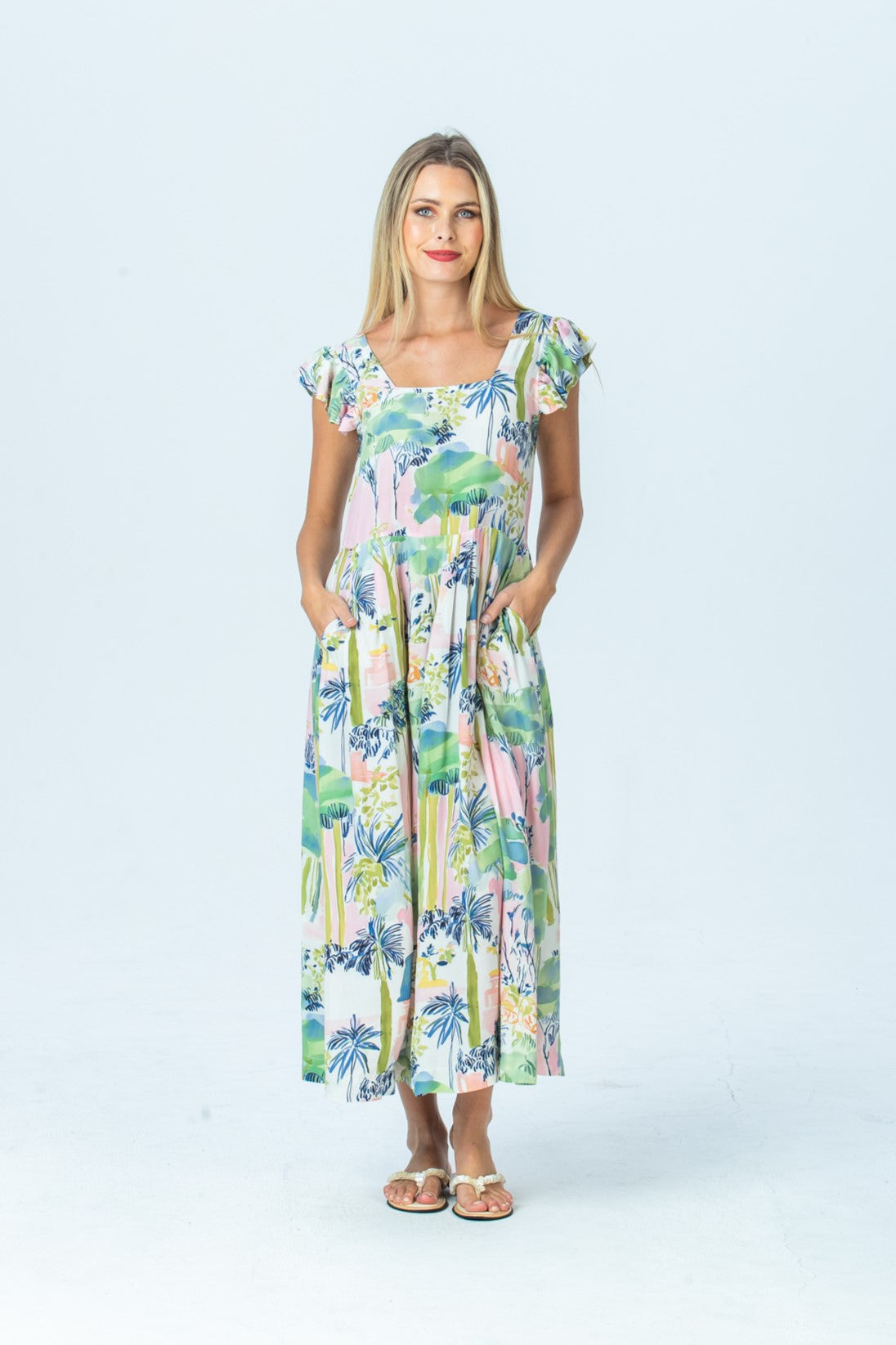 Sienna watercolour palm sundress, front view full length with hands in pockets