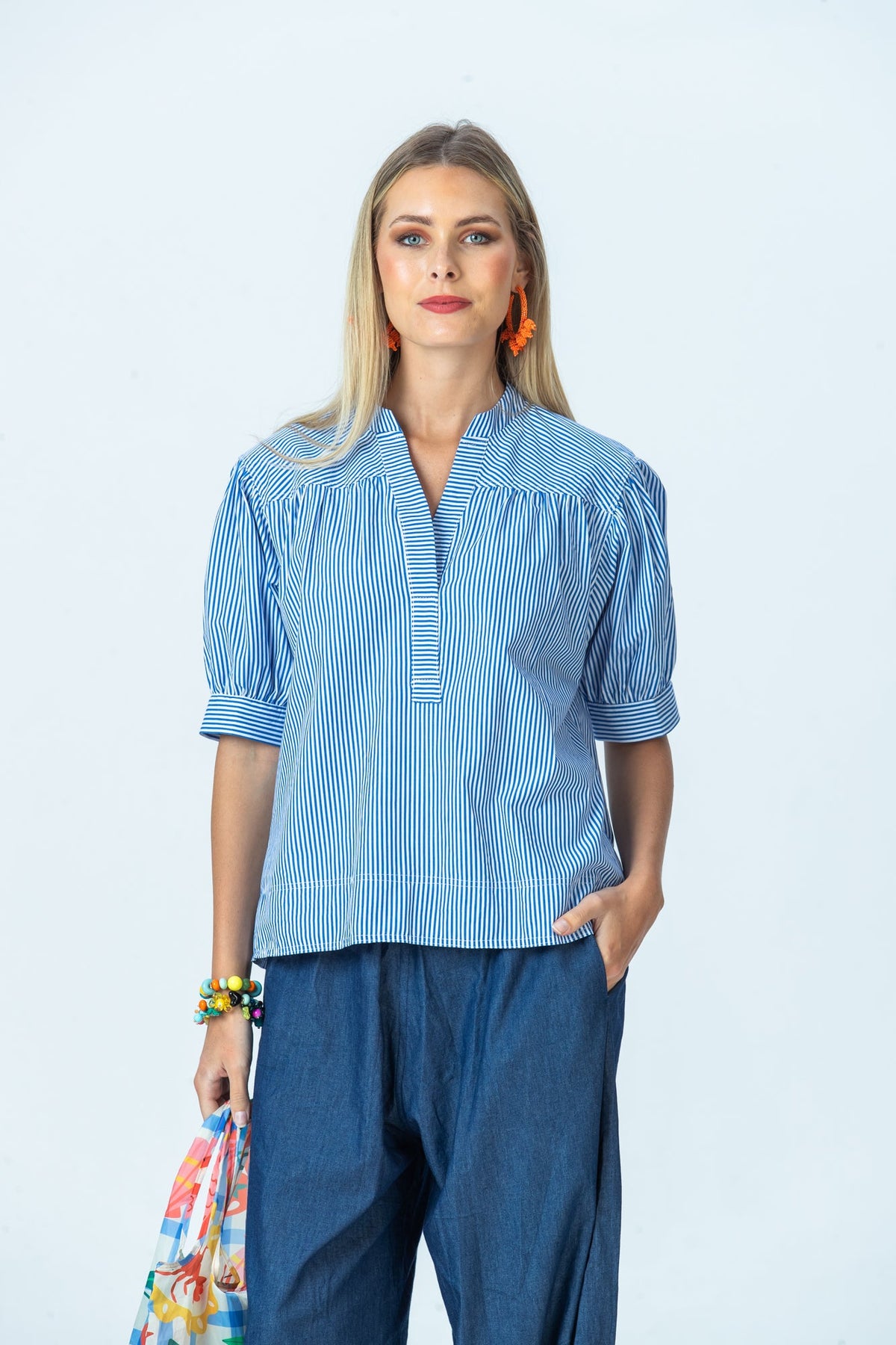 Tatum blue stripe shirt, front view with hand in pocket