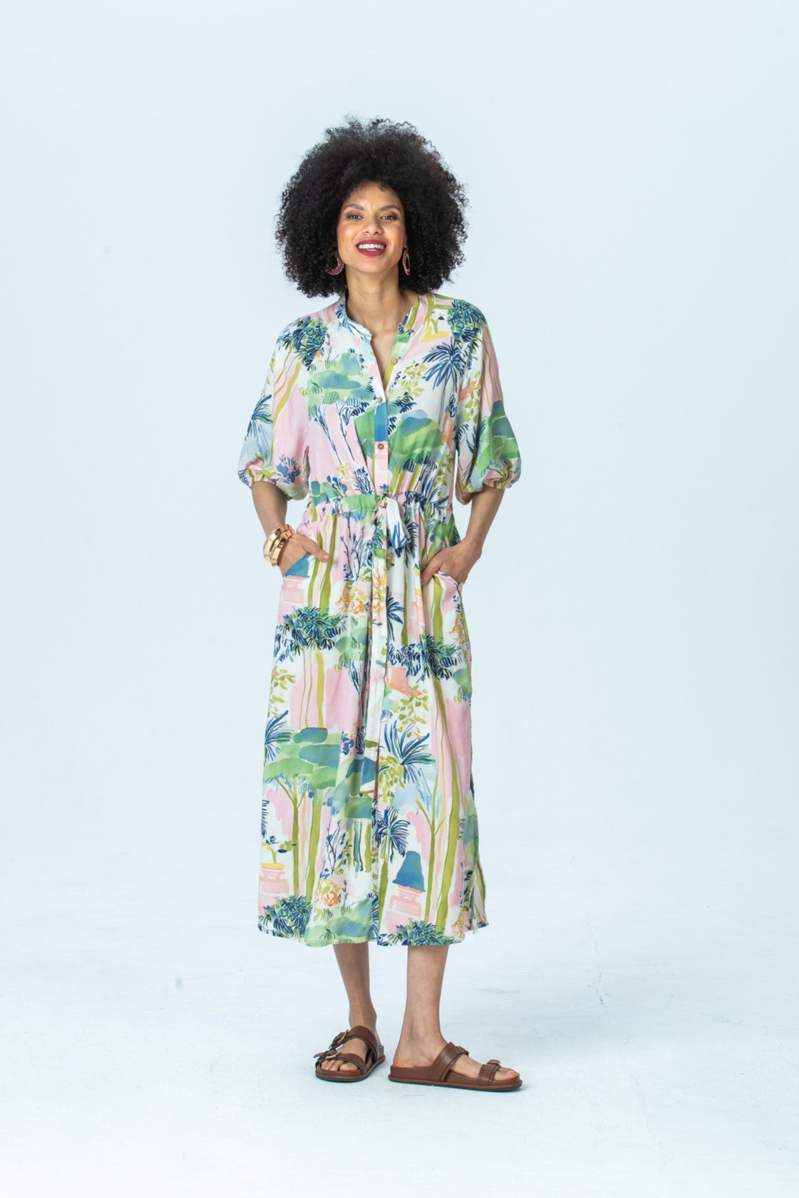 Shelby watercolour palm dress, front view full length with hands in pockets