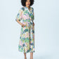 Shelby watercolour palm dress, three-quarter view full length with hand in pocket