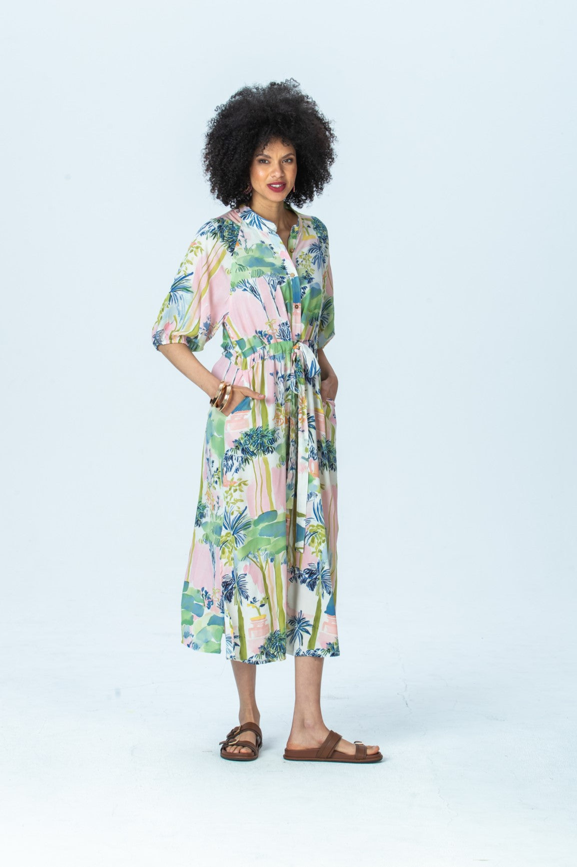 Shelby watercolour palm dress, three-quarter view full length with hand in pocket