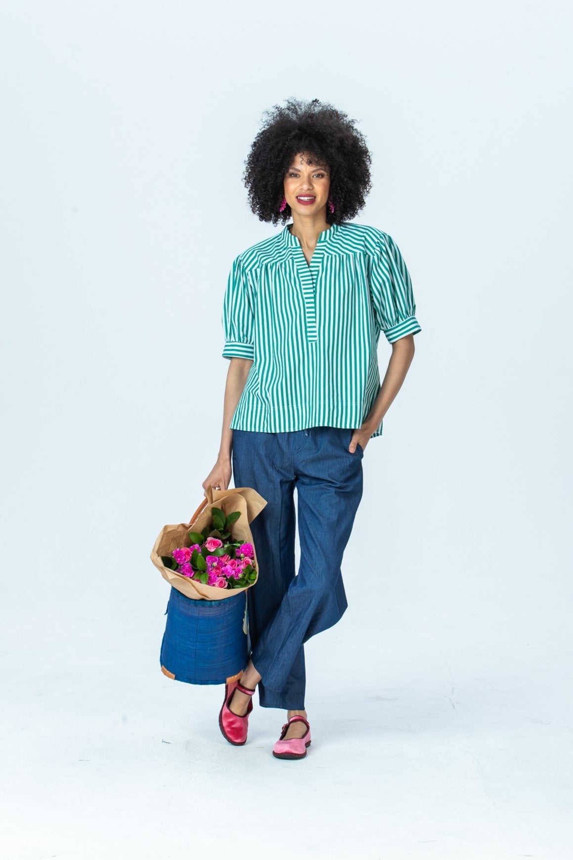 Tatum emerald stripe shirt, front view full length holding flowers