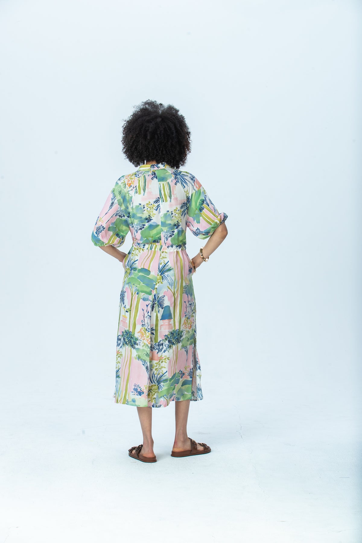 Shelby watercolour palm dress, back view full length with hands on hips