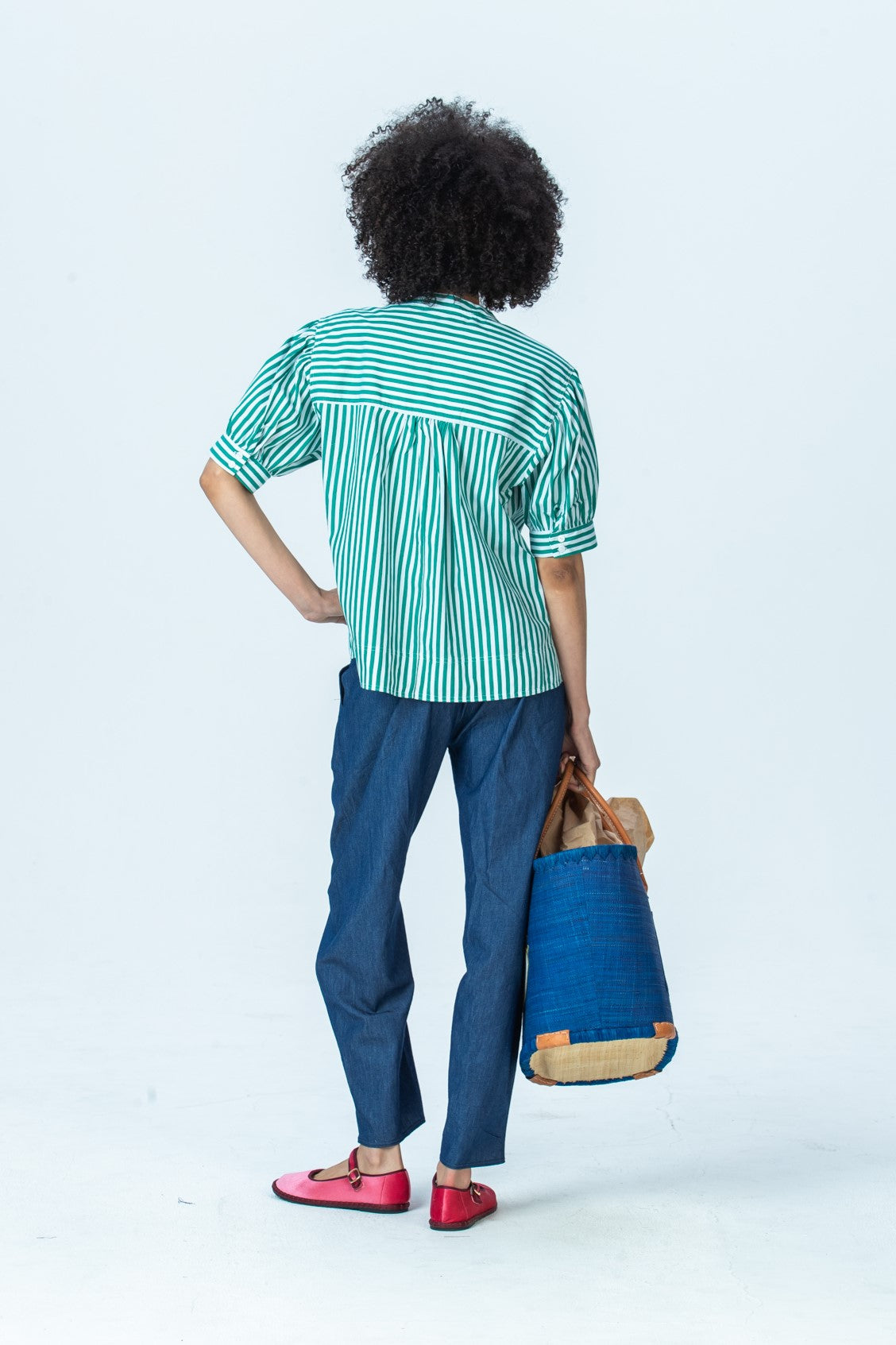 Tatum emerald stripe shirt, back view full length with hand on hip
