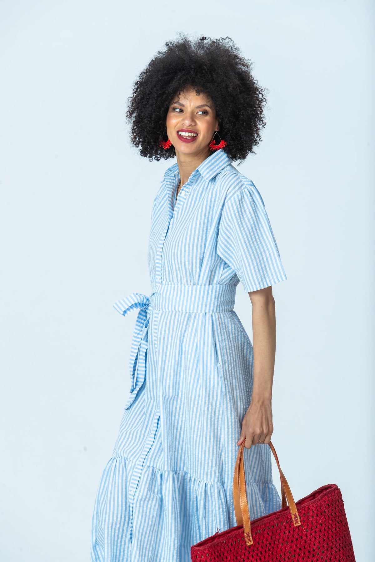 Frankie blue stripe shirt dress, three-quarter view looking to the side, belted