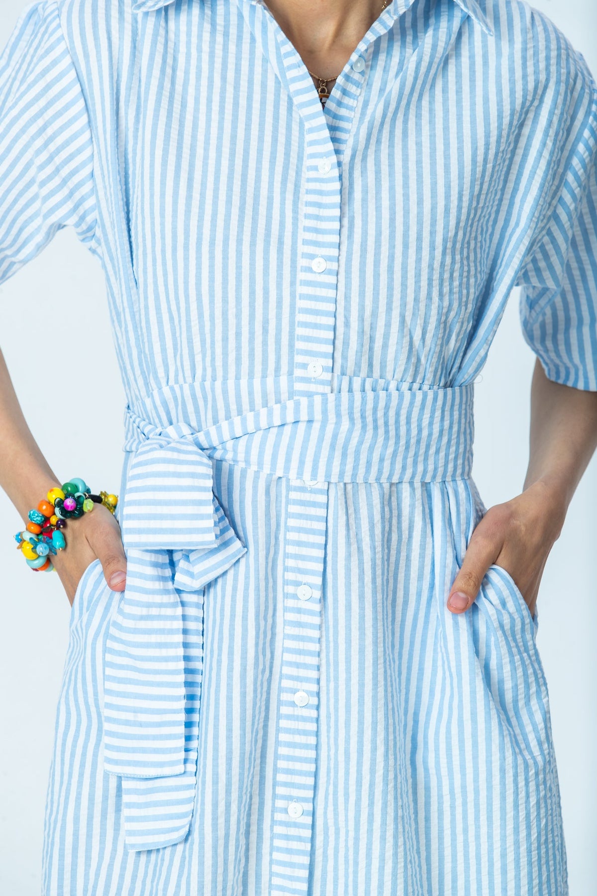 Frankie blue stripe shirt dress, close up of button placket, self-tie belt and pockets