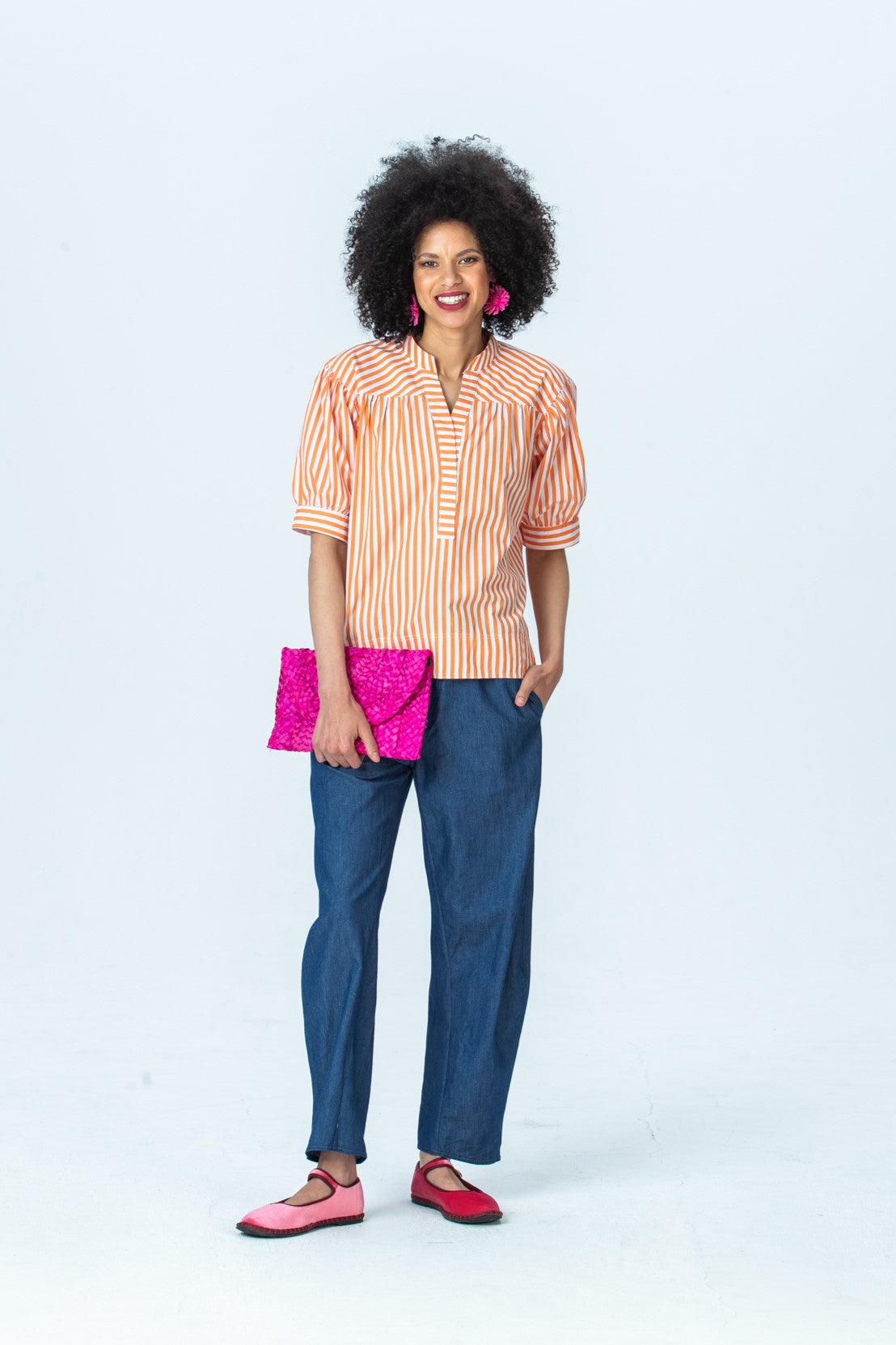 Tatum orange stripe shirt, front view full length with hand in pocket