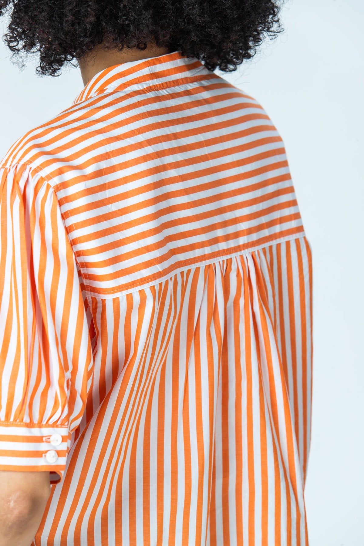 Tatum orange stripe shirt, close up of horizontal stripe back yoke and two-button cuff
