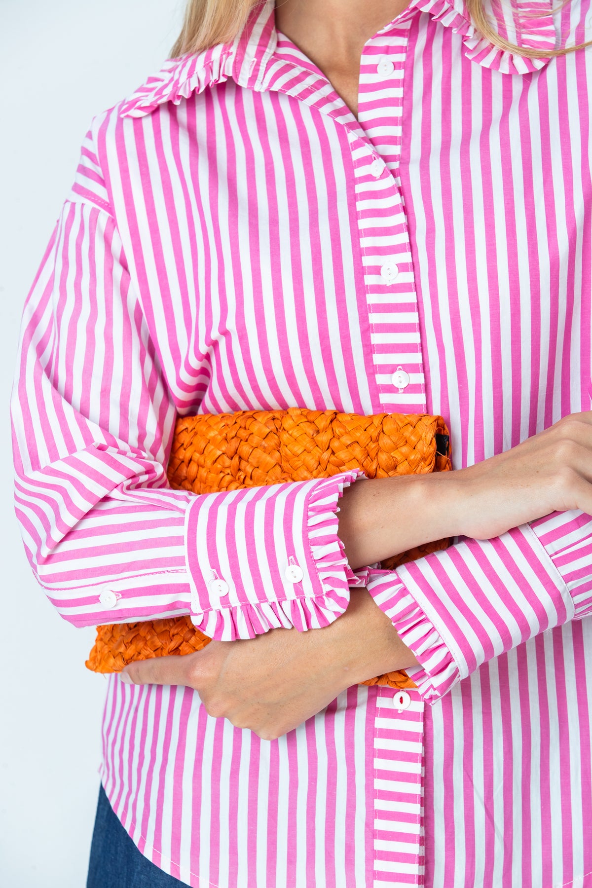 Claire frill shirt, close-up of frilled buttoned cuffs with arms crossed
