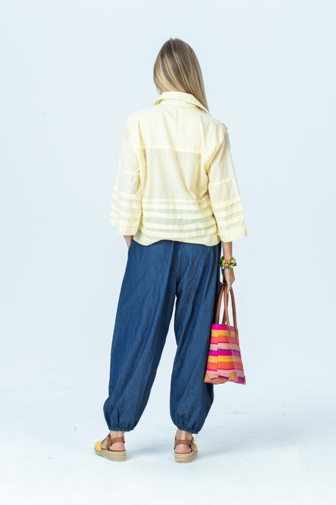 Serafina pale yellow shirt, back view full length with Stella balloon pants