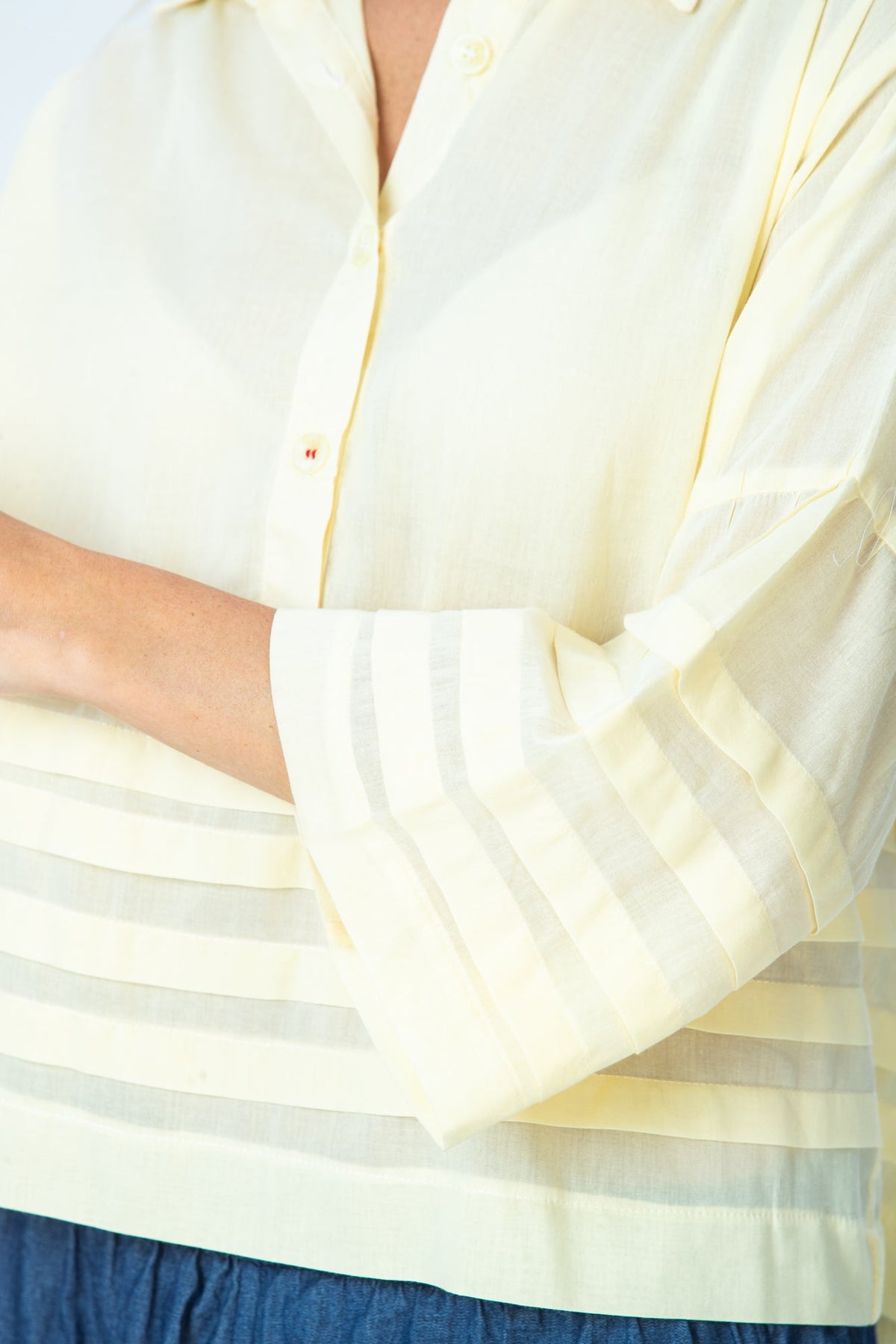 Serafina pale yellow shirt, close up of pleated cuff and pintuck band