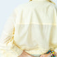 Serafina pale yellow shirt, back view close up of collar, sleeve and pintuck band