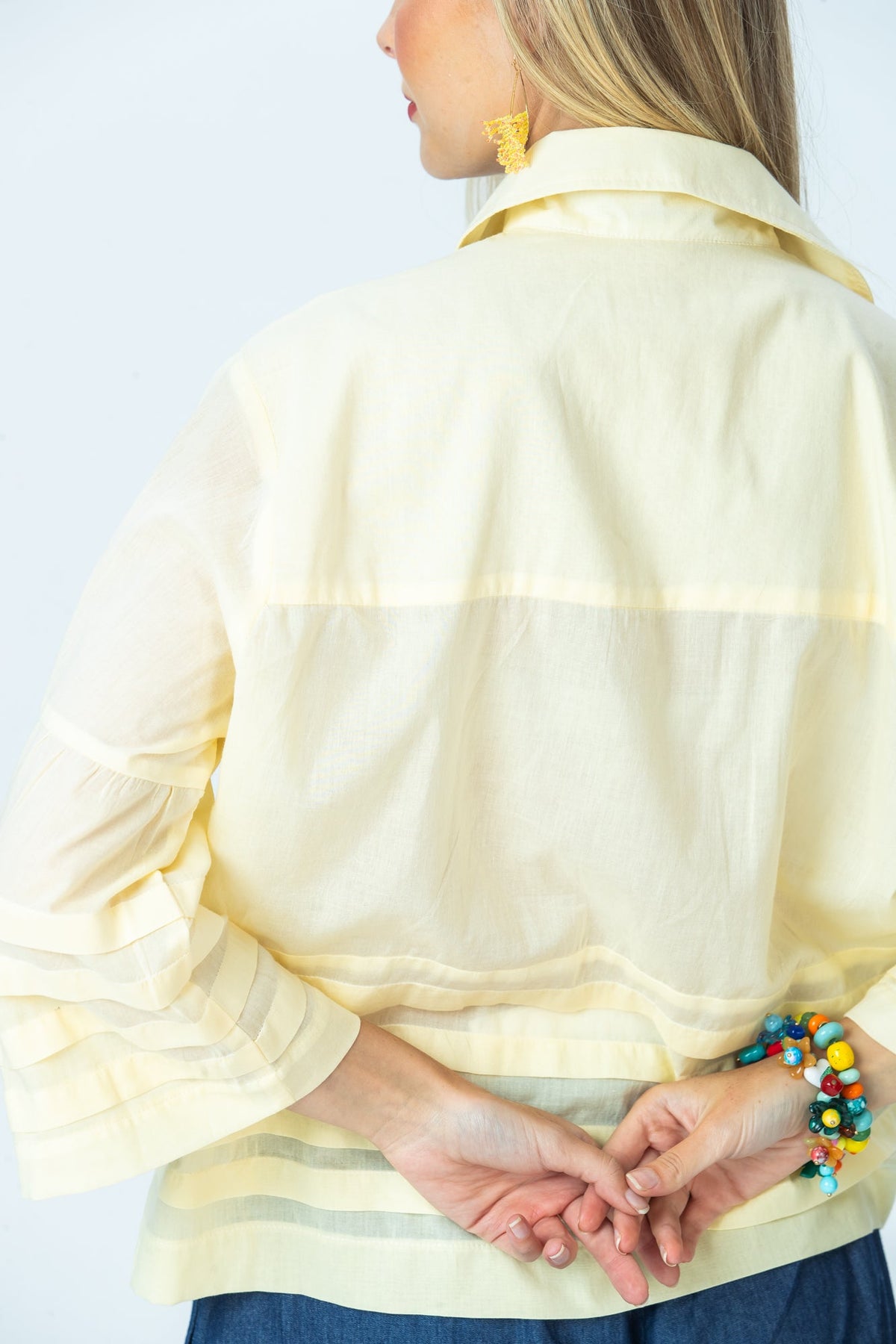 Serafina pale yellow shirt, back view close up of collar, sleeve and pintuck band