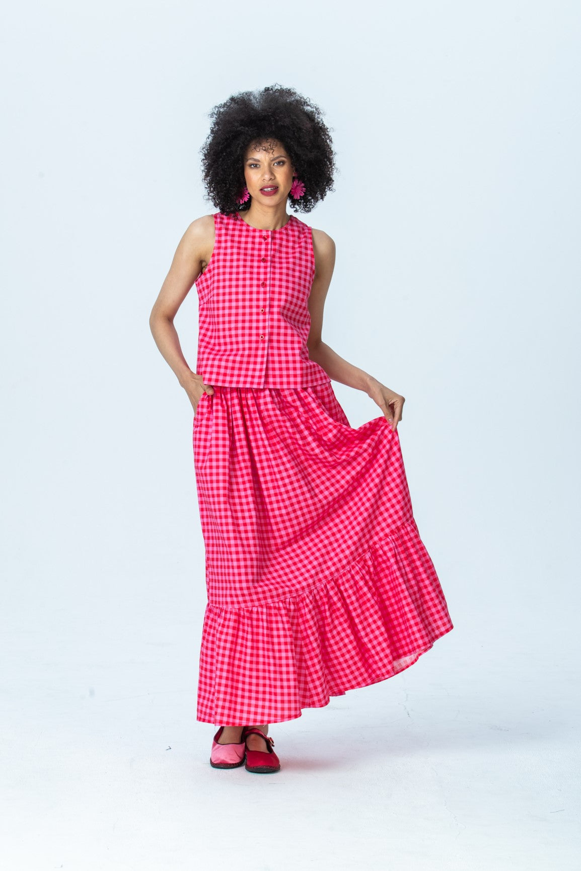 Riley red and pink check skirt, front view full length holding out the skirt
