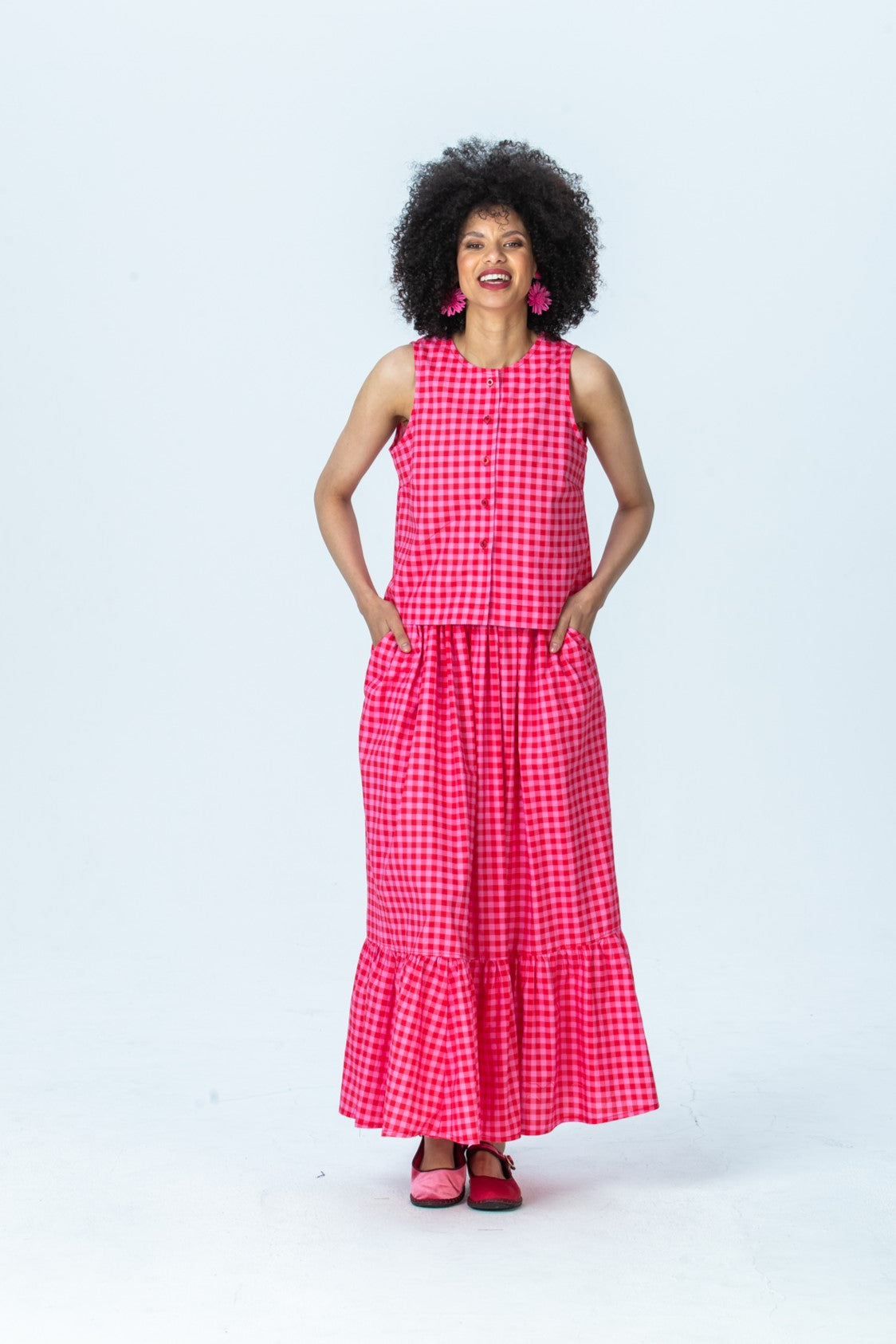 Riley pink gingham maxi skirt, front view full length with hands in pockets