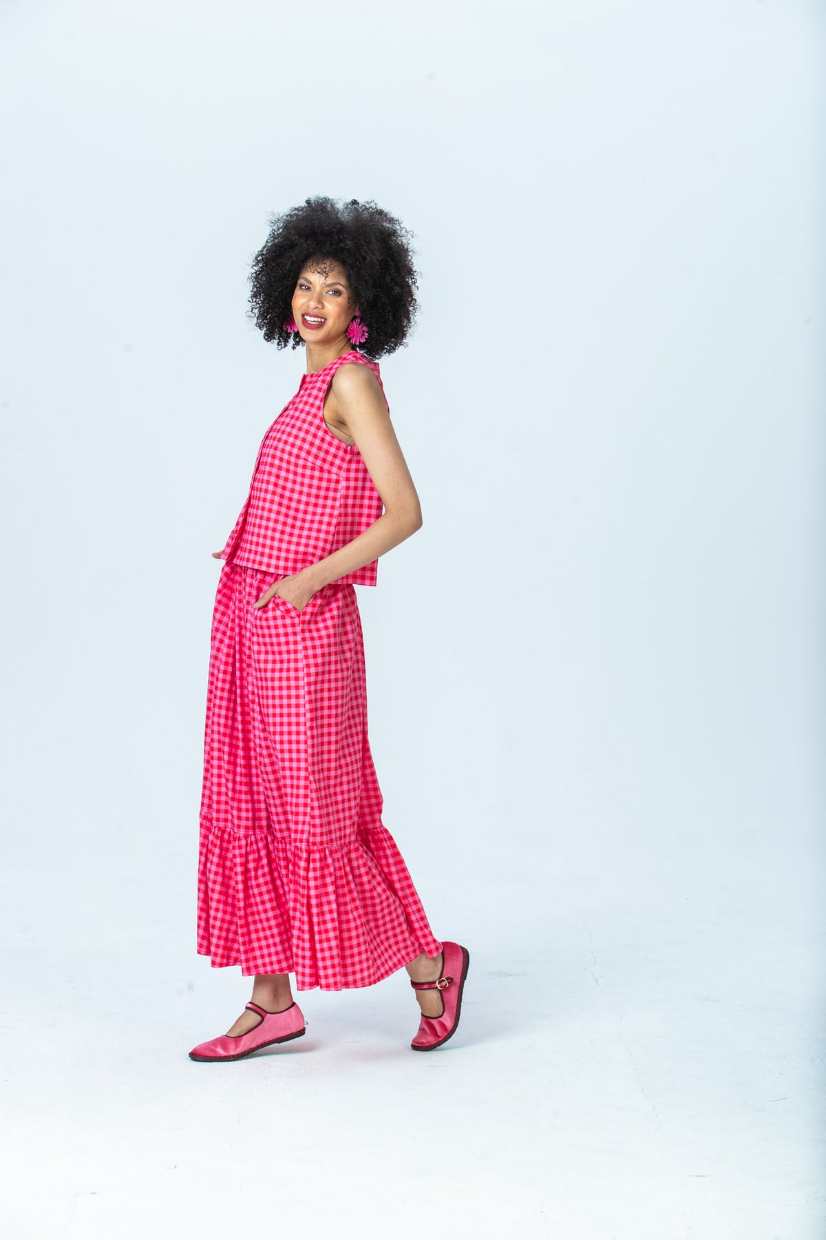 Brooke red and pink check top, side view walking with the Riley skirt