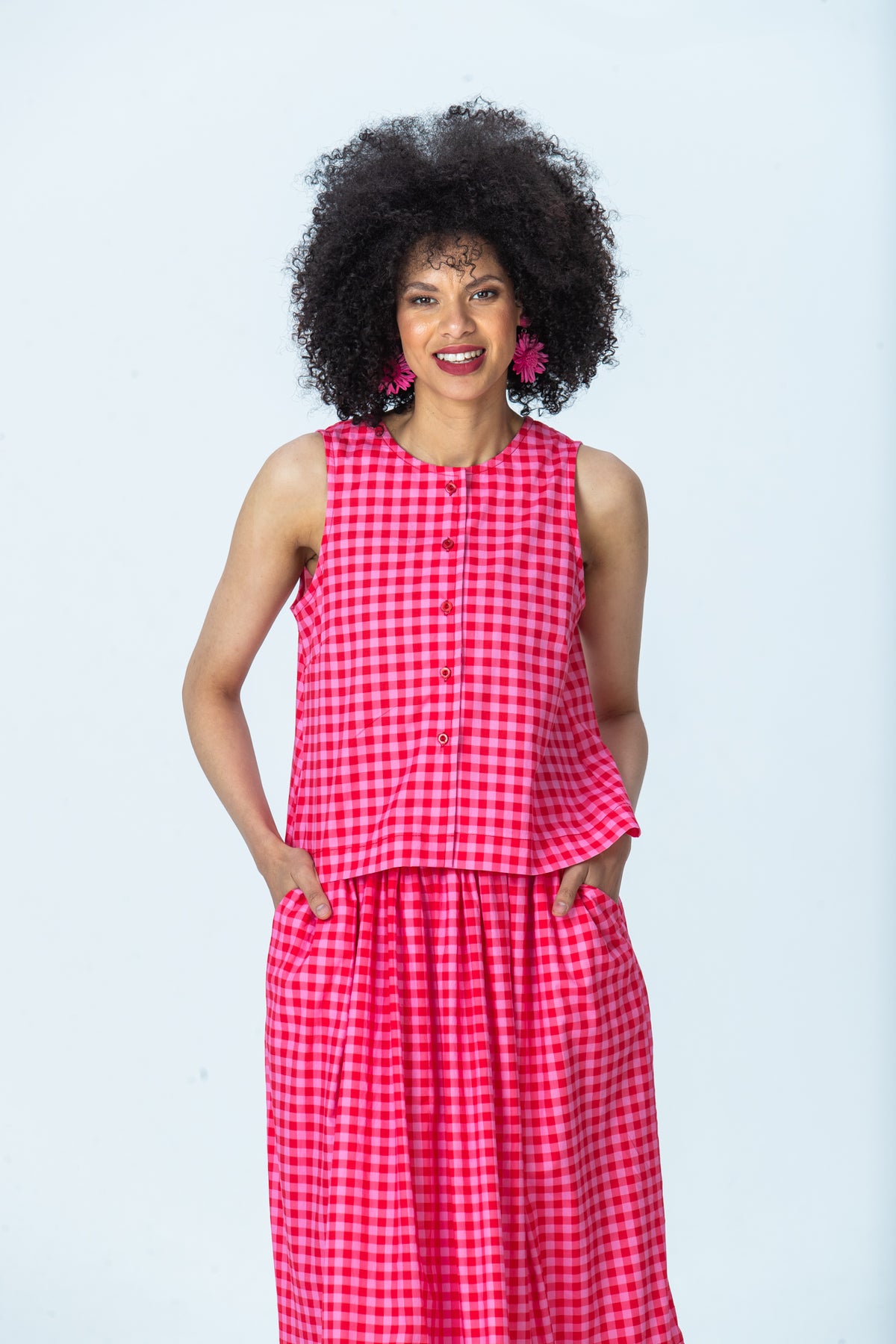 Brooke red and pink check top, front view with hands in pockets