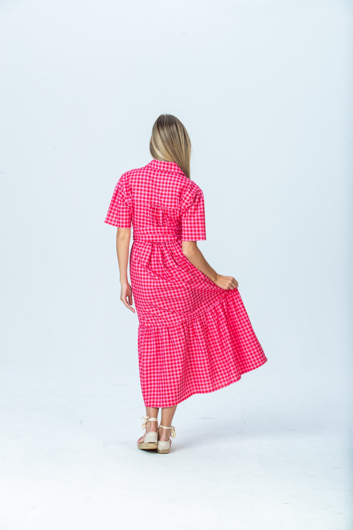 Frankie red and pink check shirt dress, back view walking with skirt in motion