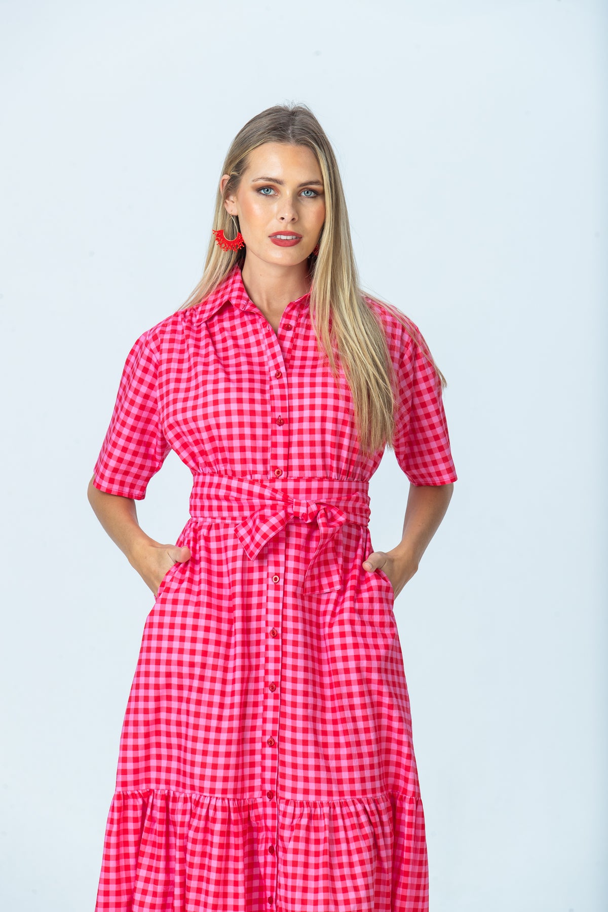 Frankie pink gingham shirt dress, front view with hands in pockets