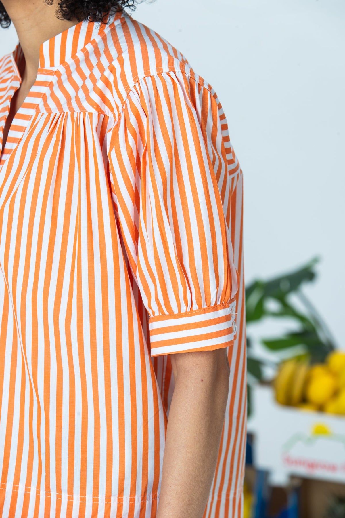Tatum orange stripe shirt, side close up of gathered sleeve and cuff