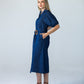 Harlow denim shirt dress in 100% cotton side view with hands in pockets