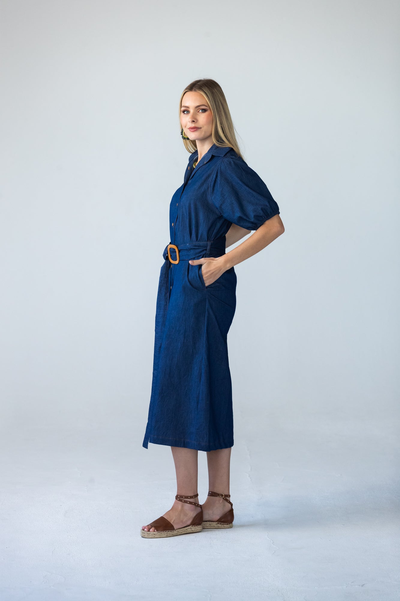 Harlow denim shirt dress in 100% cotton side view with hands in pockets
