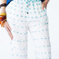 Sydney teal brushstroke wide leg pants, close up front view showing pocket and drawcord