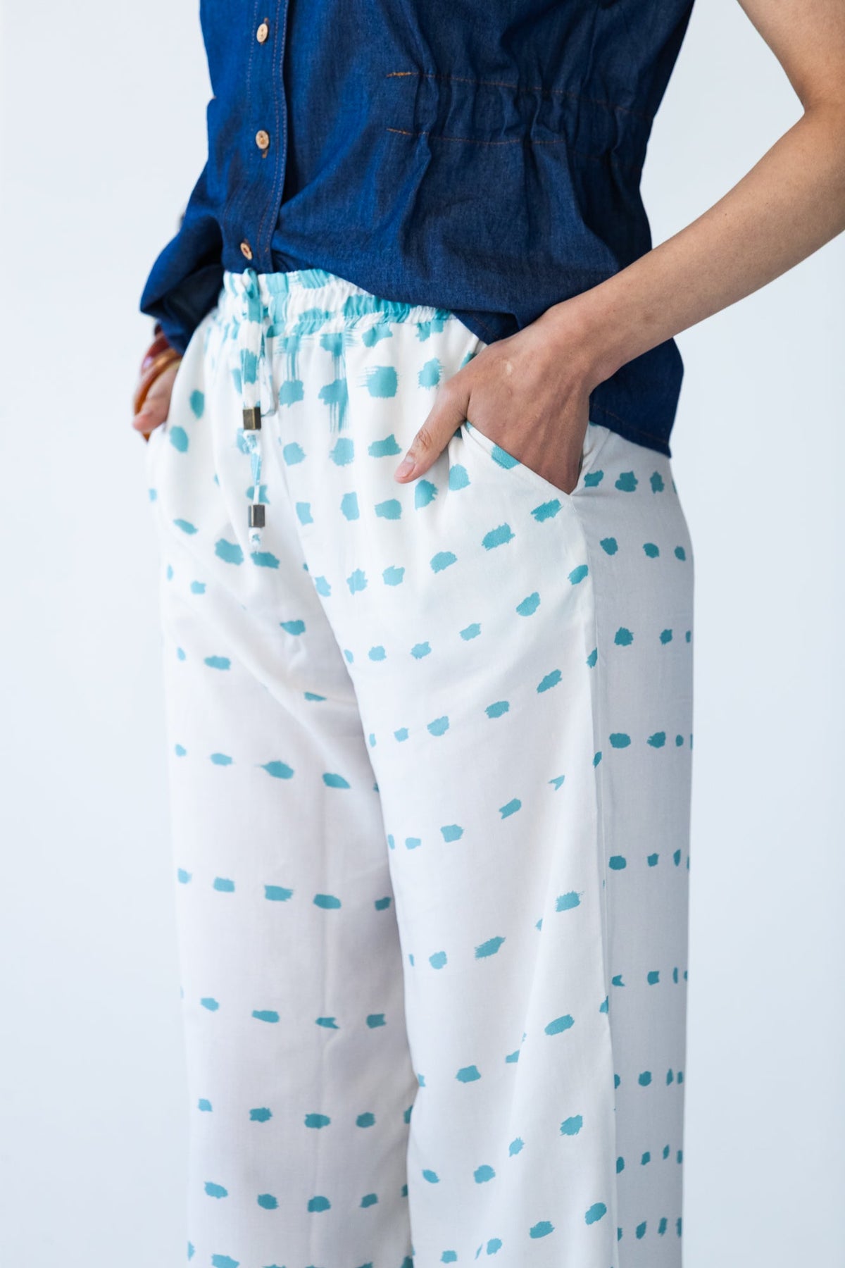 Sydney teal brushstroke wide leg pants, close up side view showing pocket and drawcord