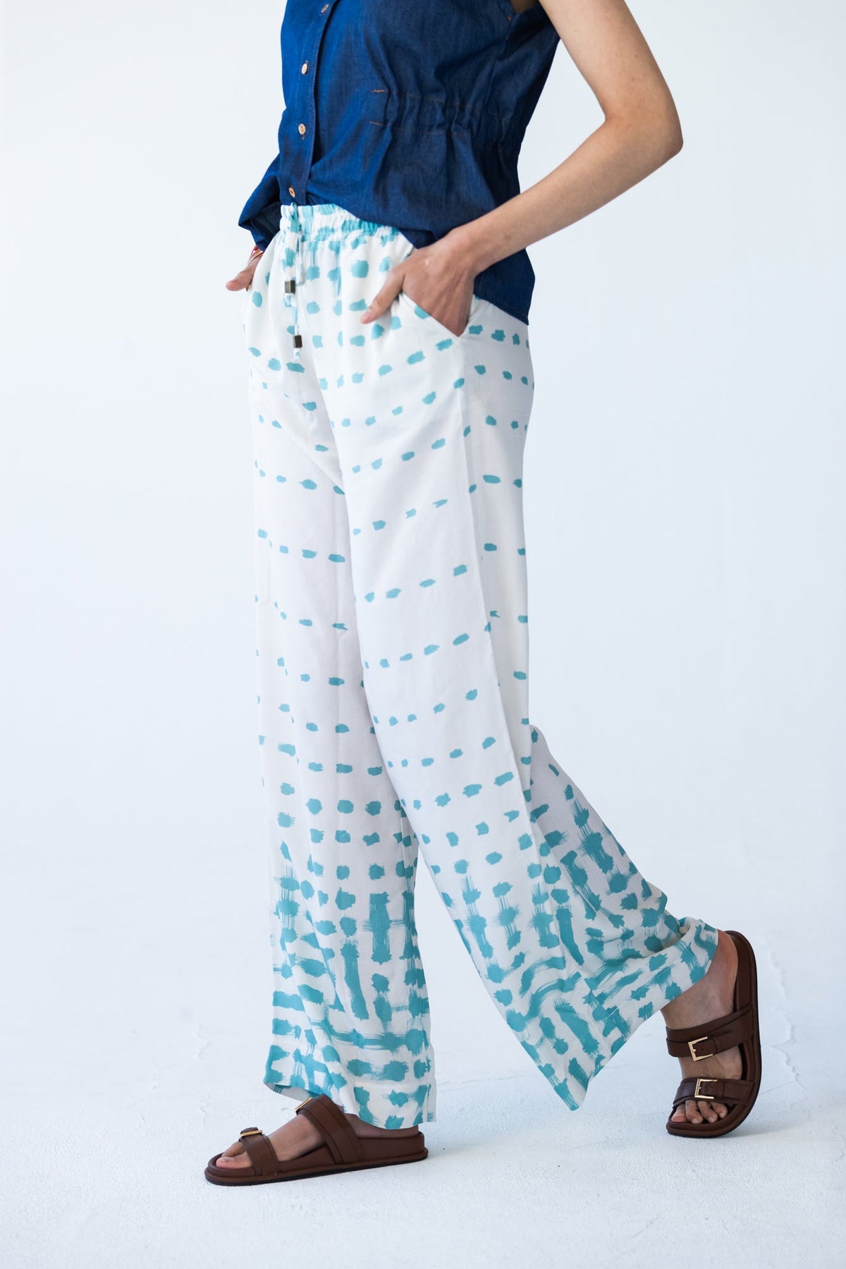 Sydney teal brushstroke wide leg pants, side profile view walking