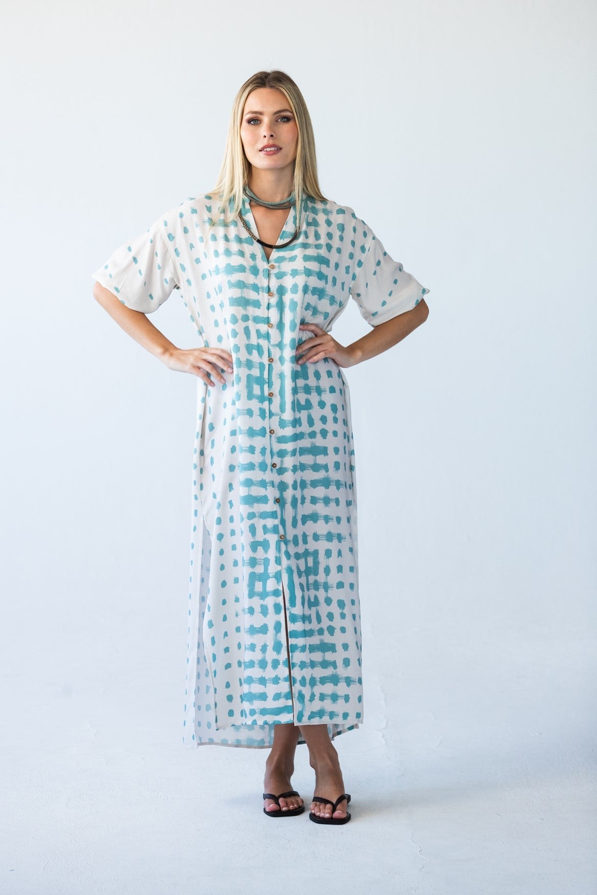 Bailey teal brushstroke kaftan, front view with hands on hips