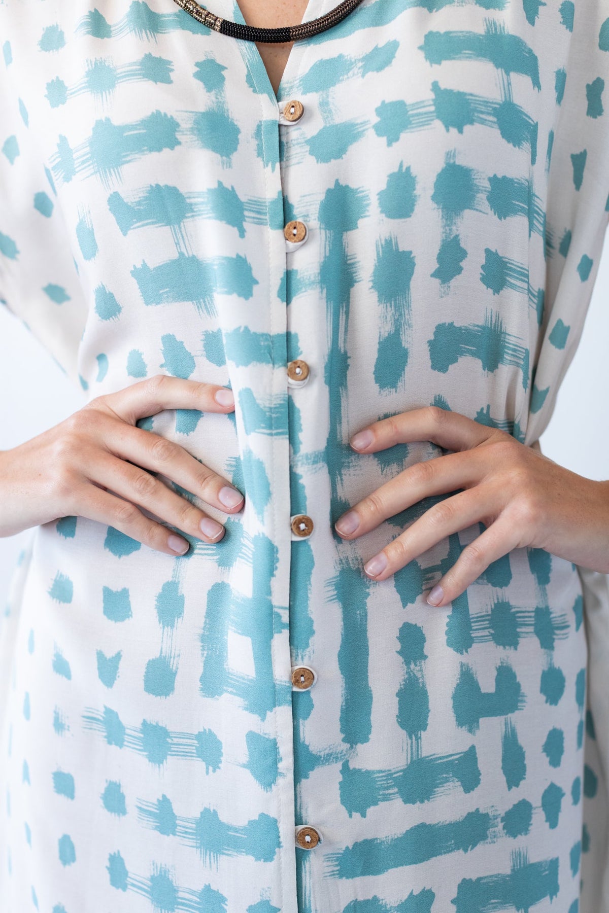 Bailey teal brushstroke kaftan, close-up of button placket
