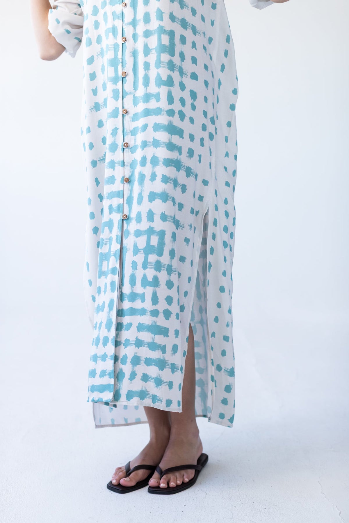 Bailey teal brushstroke kaftan, close-up of hem showing side slit