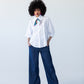 Claire frill shirt, full-length front view styled with Blair wide-leg denim pants and neck scarf