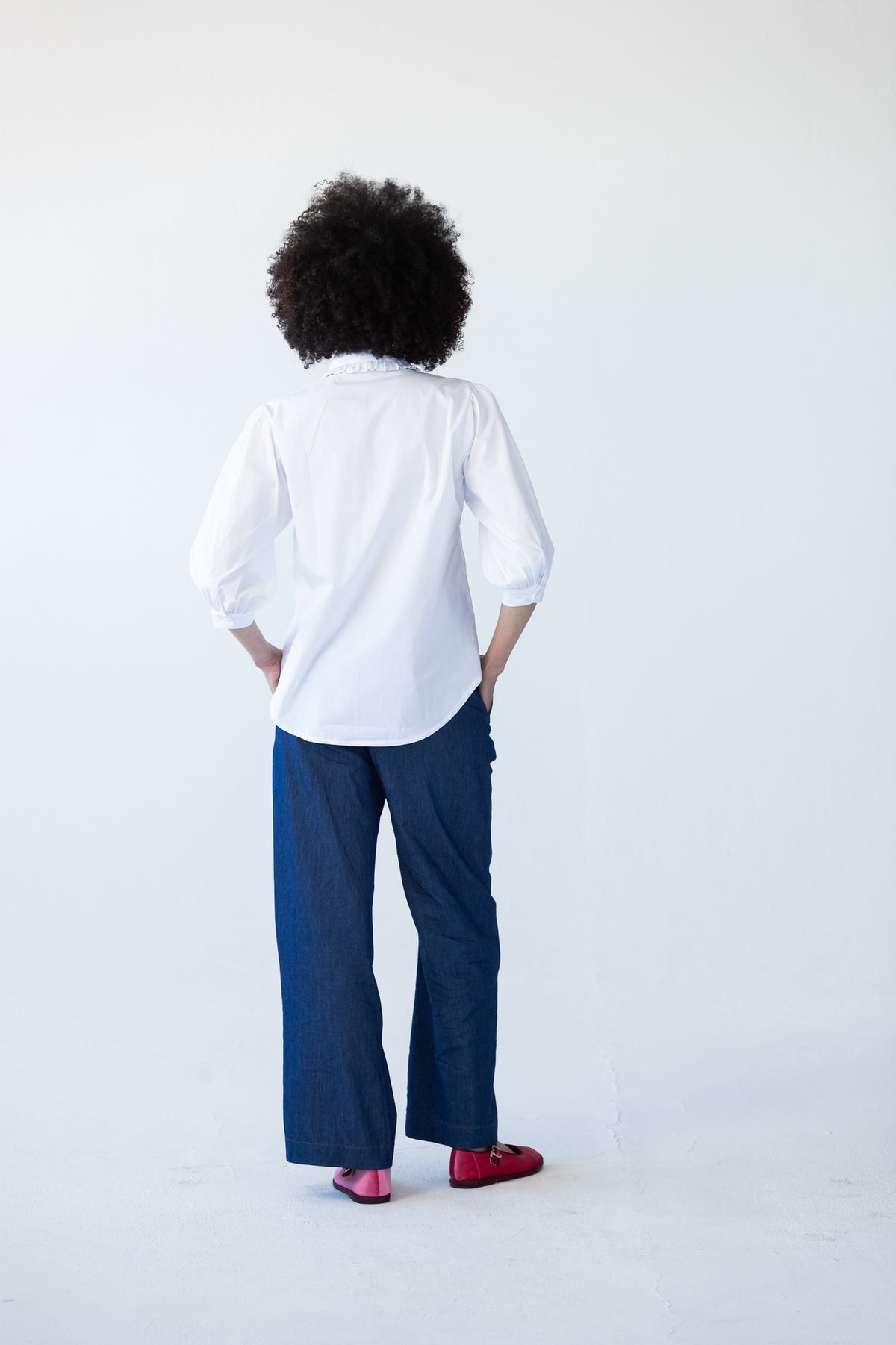 Claire frill shirt, back view styled with Blair wide-leg denim pants
