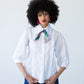 Claire white frill shirt, front view with neck scarf, styled with wide-leg denim pants