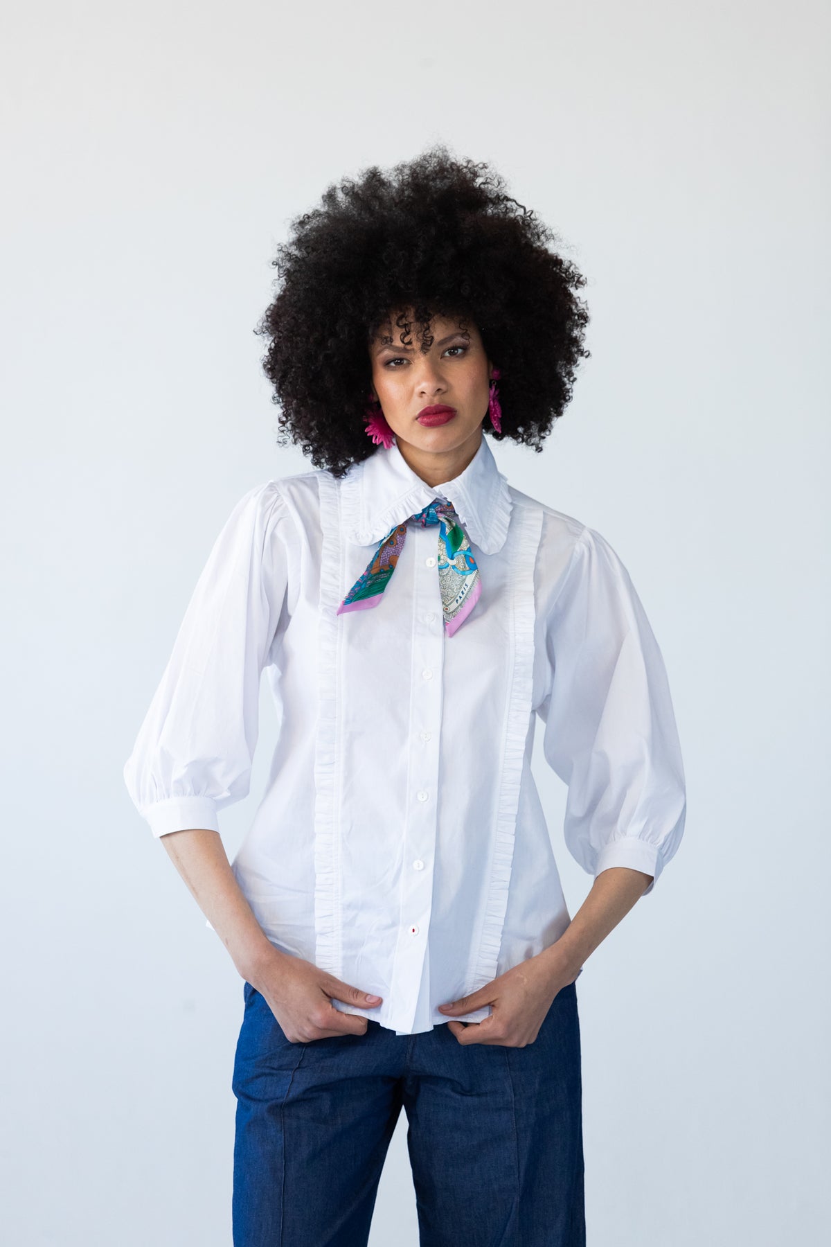 Claire white frill shirt, front view with neck scarf, styled with wide-leg denim pants